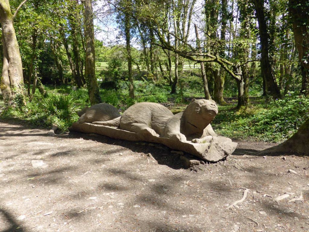 Carving of two otters (Lutra lutra) at Otter bridge, Tehidy Country Park.
